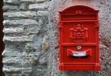 a red mailbox on the side of a building